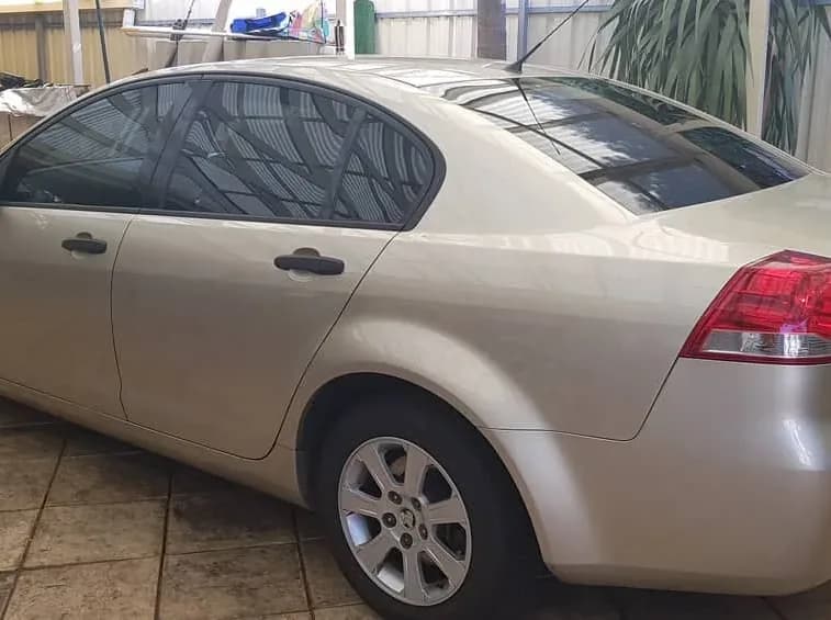Champagne Holden Commodore with a medium 35 percent window tint, the darkest legal front shade