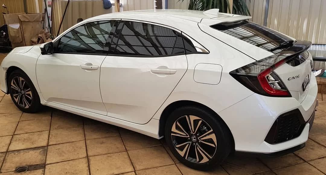 White Honda Civic hatch with tinted windows