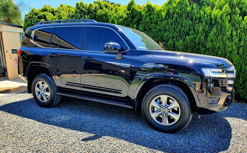 Black Toyota LandCruiser 300 with dark window tint