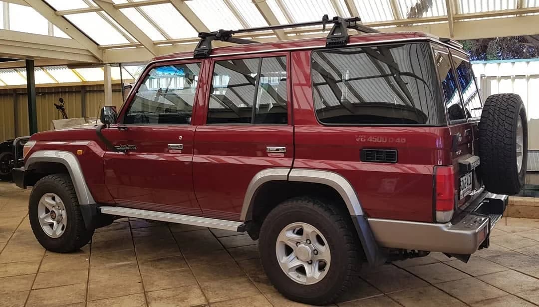 Red Toyota LandCruiser 76 Series wagon with tinted windows by Pro Tint Adelaide