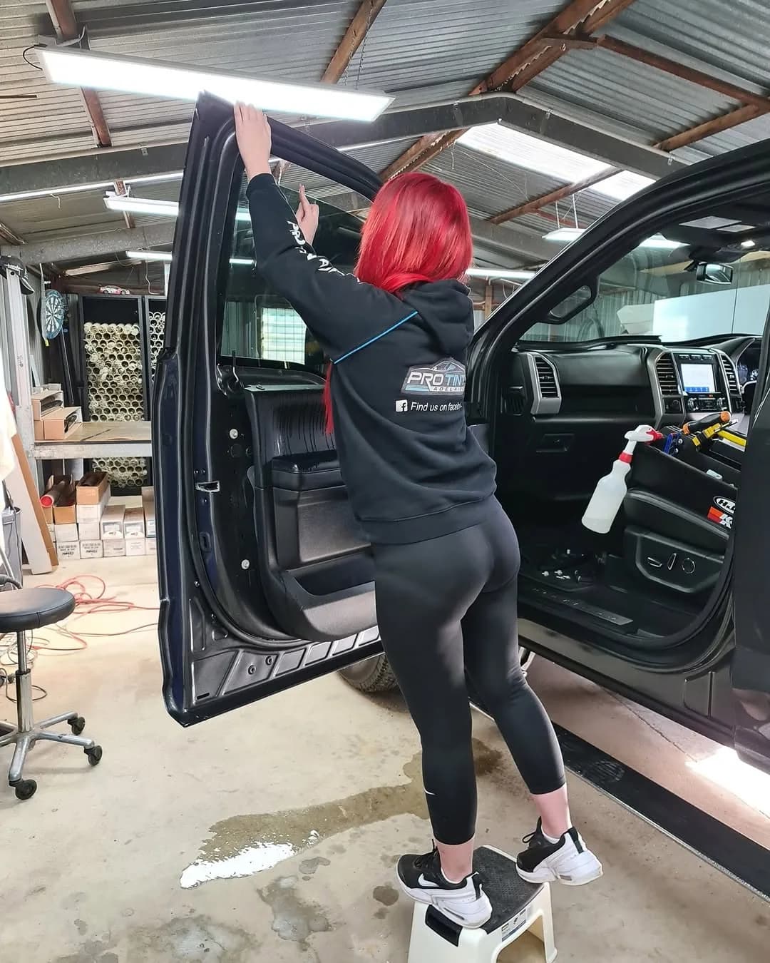 Applying window tint film to a front door window at Pro Tint Adelaide