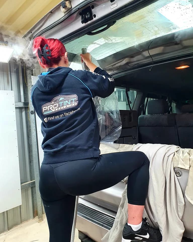 Maybellene heat-forming window tint onto a rear windscreen at Pro Tint Adelaide
