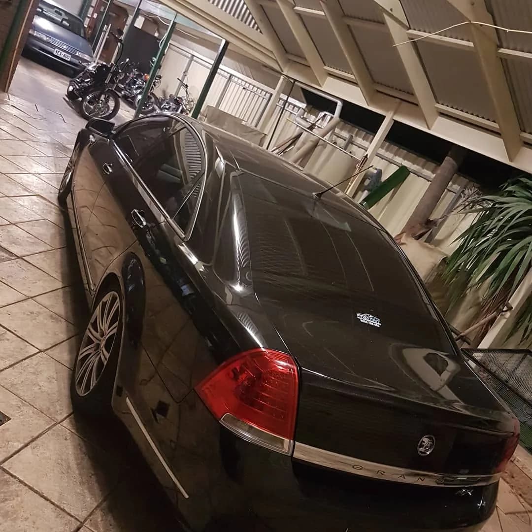 Black Holden Commodore with dark window tint in the Pro Tint Adelaide workshop