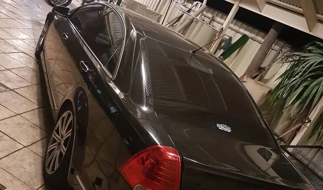 A car in the dim Pro Tint Adelaide workshop before tinting