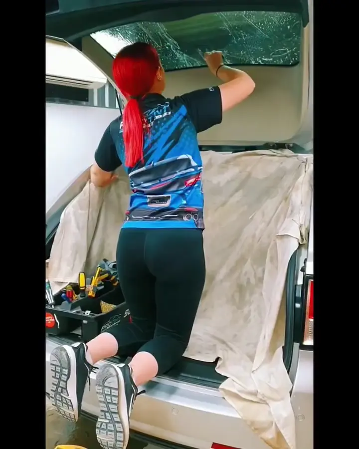 Applying precision-cut tint film to a car window at Pro Tint Adelaide